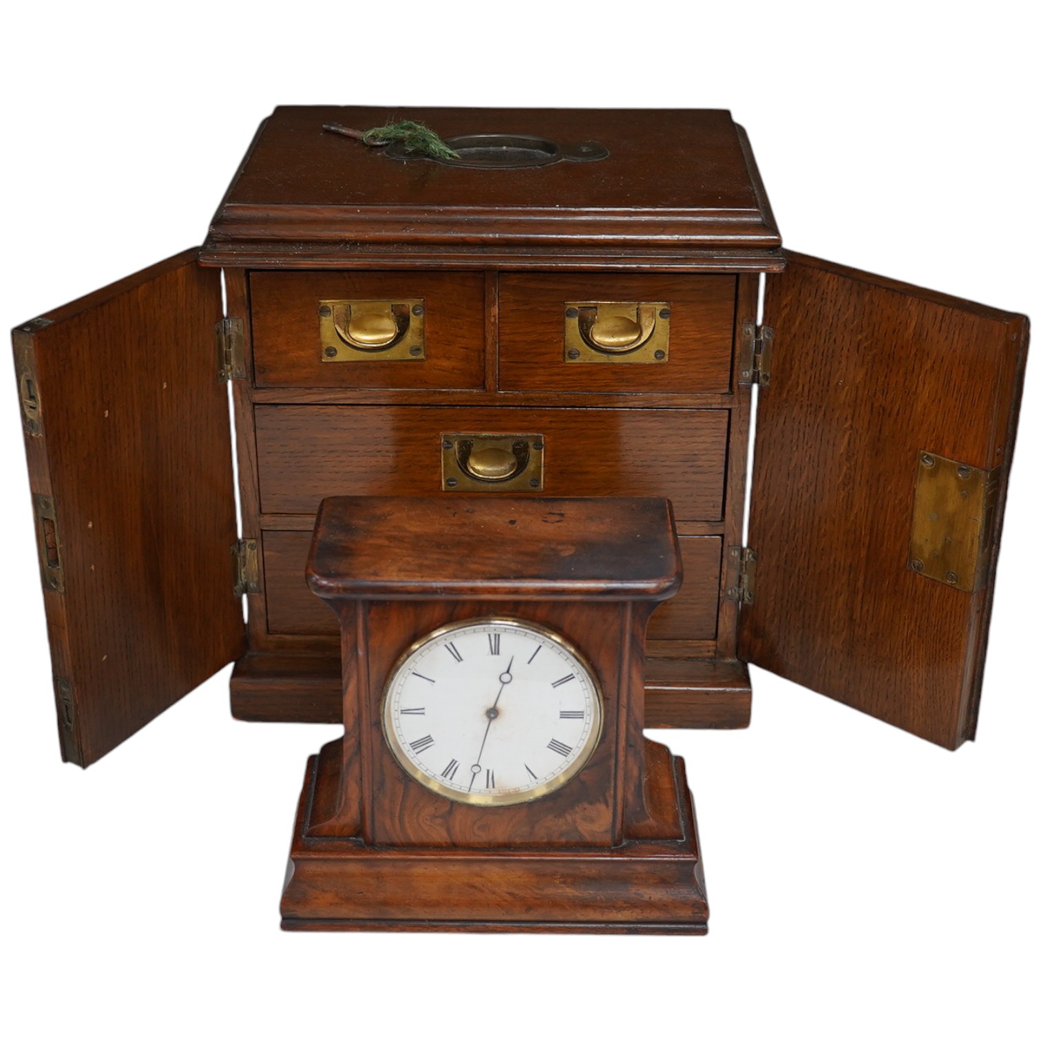 A Victorian oak two door, four drawer, vertu cabinet, with brass drawer military style handles and walnut timepiece, 29cm high, 28cm wide. Condition - fair to good